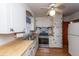 Cozy kitchen with stainless steel appliances, wooden countertop, and white cabinetry at 1226 Forestwood Dr, Charleston, SC 29407