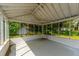 Relaxing screened porch with a swing and views of the landscaped backyard at 1226 Forestwood Dr, Charleston, SC 29407