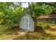 Practical storage shed in the backyard, surrounded by trees and greenery at 1226 Forestwood Dr, Charleston, SC 29407