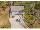 Aerial view of a charming home with a spacious driveway and beautiful landscaping including palm trees at 123 Jungle Rd, Edisto Island, SC 29438