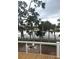 Scenic outdoor patio area with a fire pit and chairs, offering views of the surrounding nature at 123 Jungle Rd, Edisto Island, SC 29438