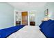Inviting bedroom with blue and white bedding and a view into the ensuite bathroom at 123 Jungle Rd, Edisto Island, SC 29438