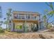 Coastal home featuring elevated design, a spacious deck, and an outdoor entertainment area underneath at 123 Jungle Rd, Edisto Island, SC 29438