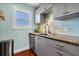 Cozy kitchen features granite countertops, gray cabinets, and stainless steel appliances at 123 Jungle Rd, Edisto Island, SC 29438