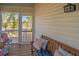 Relaxing screened porch with comfortable seating and scenic views of palm trees and outdoor landscape at 123 Jungle Rd, Edisto Island, SC 29438