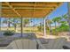 Relax on the outdoor space with seating area, overlooking serene marsh views and mature landscaping at 123 Jungle Rd, Edisto Island, SC 29438