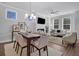 Combined living and dining area with a dining table, modern lighting, fireplace and a neutral color palette at 129 Brown Swiss Cir, Summerville, SC 29483