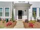 Inviting front entrance with a black door and well-manicured landscaping and home number at 129 Brown Swiss Cir, Summerville, SC 29483