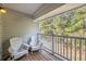 Relaxing balcony with chairs and a peaceful view of the surrounding trees at 1300 Park West Blvd # 811, Mount Pleasant, SC 29466