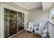 Relaxing balcony featuring comfortable Adirondack chairs and sliding glass doors with views of the surrounding nature at 1300 Park West Blvd # 811, Mount Pleasant, SC 29466