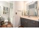 Clean bathroom with grey vanity, spacious shower, and wood-look flooring at 1300 Park West Blvd # 811, Mount Pleasant, SC 29466