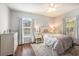 Inviting bedroom with natural light, two windows, hardwood floors, and stylish furnishings at 1300 Park West Blvd # 811, Mount Pleasant, SC 29466