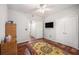 Bedroom with hardwood floors, ceiling fan, and a TV mounted on the wall at 1300 Park West Blvd # 811, Mount Pleasant, SC 29466