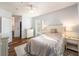 Light-filled bedroom featuring hardwood floors, two windows, and a neutral color scheme at 1300 Park West Blvd # 811, Mount Pleasant, SC 29466
