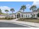 Beautiful clubhouse entrance featuring palm trees, well-kept landscaping, and architectural roof detail at 1300 Park West Blvd # 811, Mount Pleasant, SC 29466