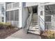 Exterior staircase leading to upper-level units, showcasing well-maintained landscaping and building facade at 1300 Park West Blvd # 811, Mount Pleasant, SC 29466