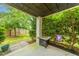 Cozy back patio with a fire pit, surrounded by lush greenery and a privacy fence at 133 Alder Cir, Charleston, SC 29412