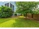 Lush backyard featuring a large tree, green lawn, and a fence, offering privacy and space for outdoor activities at 133 Alder Cir, Charleston, SC 29412