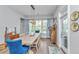 Bright dining room with a wooden table, blue accent chairs, and a decorative light fixture at 133 Alder Cir, Charleston, SC 29412