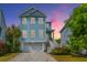 Charming two-story home with blue siding, white trim, garage, and well-manicured landscaping at 133 Alder Cir, Charleston, SC 29412