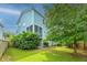 Charming two-story home with light blue siding, a screened-in porch, and a lush green lawn at 133 Alder Cir, Charleston, SC 29412