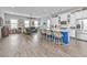 Open-concept kitchen with a large island, white cabinets, and stainless steel appliances seamlessly connects to living area at 133 Alder Cir, Charleston, SC 29412
