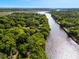 Scenic aerial view showcasing the neighborhood homes amongst the trees with access to the serene river at 1405 S Edgewater Dr, Charleston, SC 29407