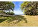 A beautiful backyard with lush lawn and mature trees offering stunning water views at 1405 S Edgewater Dr, Charleston, SC 29407