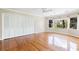 Bright bedroom featuring hardwood floors, ample closet space, and outdoor views at 1405 S Edgewater Dr, Charleston, SC 29407