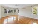 Sun-filled bedroom featuring hardwood floors, and large windows showcasing outdoor views at 1405 S Edgewater Dr, Charleston, SC 29407