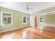 Light-filled bedroom with hardwood floors, mirrored closet, and bright green walls at 1405 S Edgewater Dr, Charleston, SC 29407