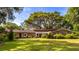 Charming single story home with manicured lawn and mature trees providing a serene outdoor space at 1405 S Edgewater Dr, Charleston, SC 29407