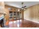 Cozy living area with a fireplace, wood paneled walls, and abundant natural light from glass doors at 1405 S Edgewater Dr, Charleston, SC 29407