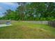 Spacious fenced backyard with a grill and lush greenery, creating a perfect outdoor space for relaxing and entertaining at 141 Clydesdale Cir, Summerville, SC 29486