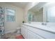 This bathroom offers dual sinks, white cabinetry, and a large mirror with views of the window at 141 Clydesdale Cir, Summerville, SC 29486