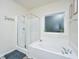 Bright bathroom features a clear glass shower stall, a large soaking tub, and neutral decor at 141 Clydesdale Cir, Summerville, SC 29486