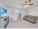 The bonus room features soft carpet, ceiling fan, and a large flatscreen television for movie nights at 141 Clydesdale Cir, Summerville, SC 29486