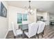 Cozy dining area with wood-look flooring, elegant furnishings, and an abundance of natural light at 141 Clydesdale Cir, Summerville, SC 29486