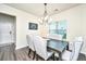 Elegant dining area featuring a wooden table, upholstered chairs, and stylish chandelier at 141 Clydesdale Cir, Summerville, SC 29486
