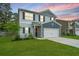 Charming two-story home with light grey siding, dark blue accents, and a well-manicured lawn at 141 Clydesdale Cir, Summerville, SC 29486