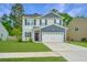 Charming two-story home features a two-car garage, a well-manicured lawn, and beautiful curb appeal at 141 Clydesdale Cir, Summerville, SC 29486