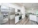 Gourmet kitchen with stainless steel refrigerator, white cabinets, granite countertops, and modern appliances at 141 Clydesdale Cir, Summerville, SC 29486