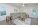 Comfortable living room features a large gray sectional, ceiling fan, and a stylish blue and beige rug at 141 Clydesdale Cir, Summerville, SC 29486