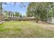 Large backyard featuring a green lawn, a wooden fence, and mature trees at 1541 Hutton Pl, Charleston, SC 29407