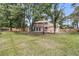 Large backyard with a wood fence and mature trees at 1541 Hutton Pl, Charleston, SC 29407