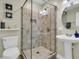 Elegant bathroom with a glass-enclosed shower, pedestal sink, and decorative accents at 1541 Hutton Pl, Charleston, SC 29407