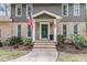 Charming two-story home with a brick facade, covered entrance, and American flag at 1541 Hutton Pl, Charleston, SC 29407