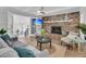 Cozy living room featuring a brick fireplace, comfortable seating, and a modern ceiling fan at 1541 Hutton Pl, Charleston, SC 29407