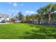 Expansive backyard featuring lush green grass, a privacy fence, and mature palm trees at 1580 Cranes Nest Rd, Mount Pleasant, SC 29466