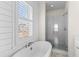 Bright bathroom with a soaking tub and glass-enclosed shower at 1580 Cranes Nest Rd, Mount Pleasant, SC 29466